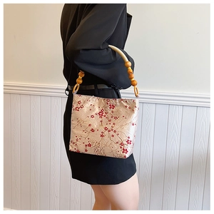Chinese style silk shoulder bag with red plum blossom embroidery and wooden bead handle