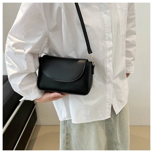 Minimalist black matte leather crossbody bag with golden metal buckle for women