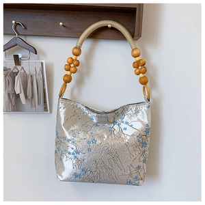 Detailed embroidery of blue plum blossoms on silver silk fabric with wooden bead handle
