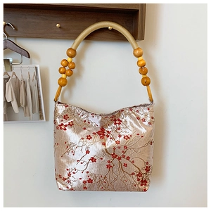 Silk shoulder bag with red plum blossom embroidery and wooden bead handle in retro style