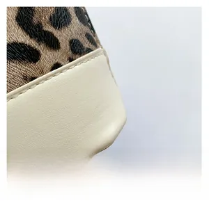 Macro detail of leopard print and cream leather stitching on the seashell bag