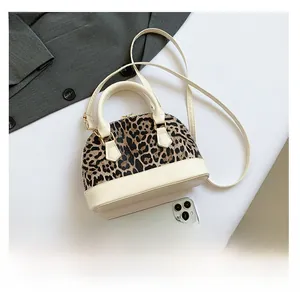 Close-up of leopard print shoulder bag with gold hardware and leather details