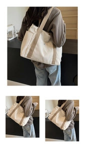 Detail of minimalist nylon tote bag featuring spacious side pocket and wide canvas strap