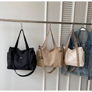 Minimalist nylon tote bags in black, khaki, and cream colors with adjustable straps