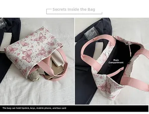Détail du grand sac cabas blanc avec imprimés papillons roses et espace de rangement