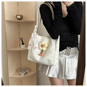 White canvas tote bag with floral accents and silk scarf handle for summer style