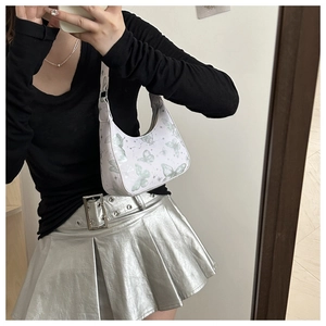 Floral butterfly printed hobo bag shown in a mirror selfie with a stylish outfit