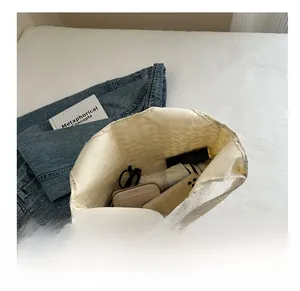 Internal view of white lace bucket bag showing capacity for phone, wallet and umbrella