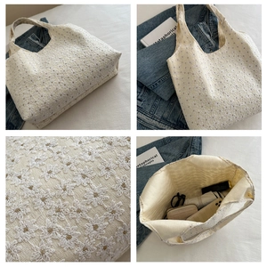 Detail view of floral tote bag with daisy embroidery and spacious interior capacity