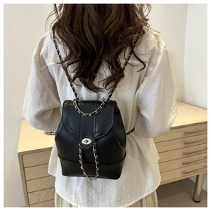 Chic black mini backpack in pearlescent faux leather with silver chain straps and metal clasp