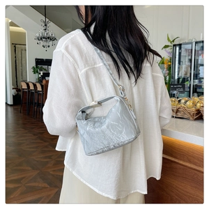Detail of silver metallic wrinkled soft PU leather handbag with elegant metal lock