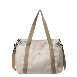 Minimalist beige nylon tote bag with silver snap button pocket and brown straps