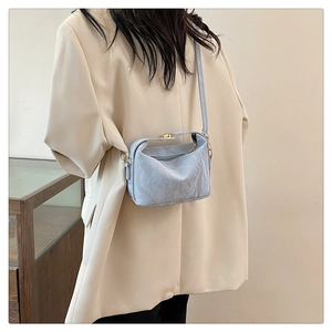 Light blue PU shoulder bag shown with chic beige blazer for stylish size reference