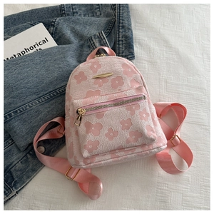 Detail of pink embroidered mini backpack with 3D floral texture and gold zipper