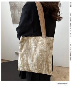 Detail of beige corduroy tote bag with white leaf pattern and premium gold snap button