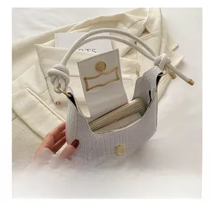 Detailed view of white crocodile texture hobo bag showing interior phone storage space