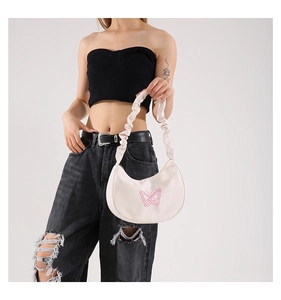 Detail of white moon bag with pink butterfly design and stylish scrunchie handle