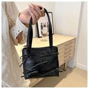 Chic black mini bucket bag with multiple bow ties and chain strap for stylish women