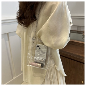 Detailed side view of clear PVC crossbody bag with silver chain and SUMMER print