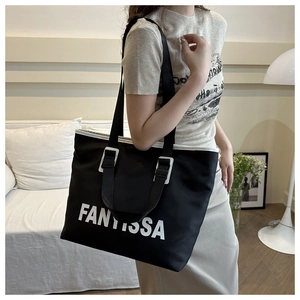 Close-up of black Oxford tote bag with white FANTISSA logo and adjustable strap detailing
