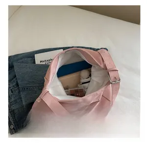 Pink suede tote bag showing spacious interior with tablet and removable coin purse