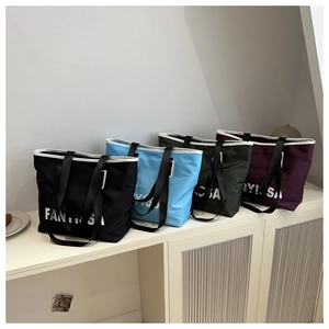 Spacious Oxford tote bags in four colors with contrast piping and wide straps