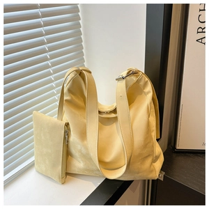 Borsa tote minimalista giallo chiaro con pochette abbinata in una stanza soleggiata