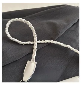 Detail of white braided PU leather handle with metallic hooks and reinforced stitching