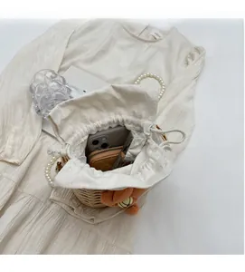 Top view of woven bucket bag interior showing capacity for phone, wallet and cosmetics