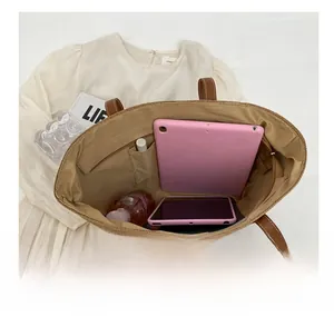 Spacious woven tote interior featuring multiple pockets for tablets and daily essentials
