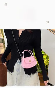 Detailed shot of pink jelly handbag with gold pearl clasp and metallic chain strap