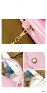 Detail of pink jelly bag showing gold chain, glossy PVC texture and large pearl buckle