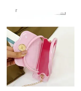 Detailed view of pink jelly bag showing golden magnetic closure and spacious interior compartment