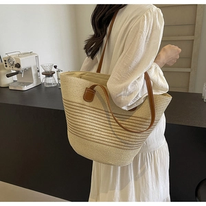 Contrast woven tote bag with brown leather handles for women in a cafe setting