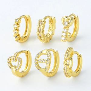 Gold plated huggie earrings set with zircon stones in geometric and heart designs