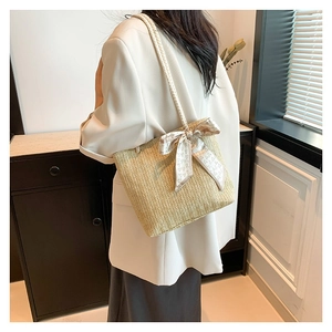 Handmade straw bucket bag with silk scarf bow and white rope handles for summer style