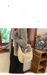 Close-up of beige nylon crescent bag featuring micro-wrinkle texture and wide shoulder strap