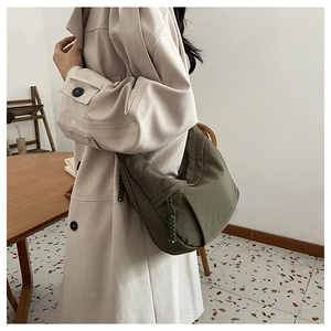 Detail view of military green nylon hobo bag with woven drawstring and wide strap