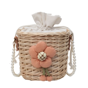 Handmade straw bucket bag with white pearl strap and decorative fabric flower