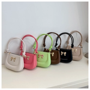 Bow-knot saddle bags in six colors featuring metallic hardware and knotted handles