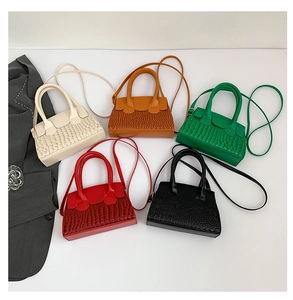 Five crocodile pattern patent leather handbags in beige, orange, green, red and black