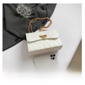 Detailed view of white quilted crossbody bag with gold chain strap and size comparison