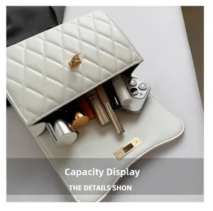 Internal view of ivory quilted leather bag showing capacity for phone and cosmetics