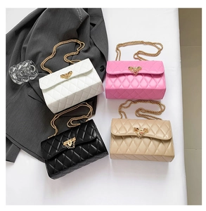 Flat lay of quilted leather crossbody bags in four colors with gold chain straps