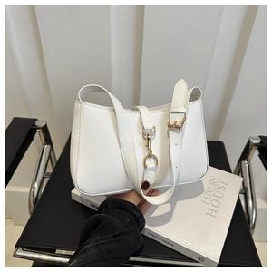 Detail of a white faux leather underarm bag with gold metal buckle and adjustable strap