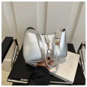 Detail of silver metallic PU underarm bag with gold buckles and adjustable shoulder strap