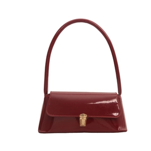 Minimalist burgundy patent leather baguette bag with golden metal buckle and curved handle