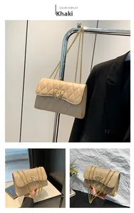Detail view of khaki quilted chain bag with elegant gold hardware and shoulder strap
