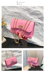 Detail of pink quilted leather bag with gold chain strap and metal triangle buckle