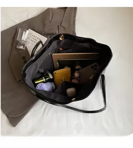 Interior view of black leather tote bag showing large capacity for daily essentials